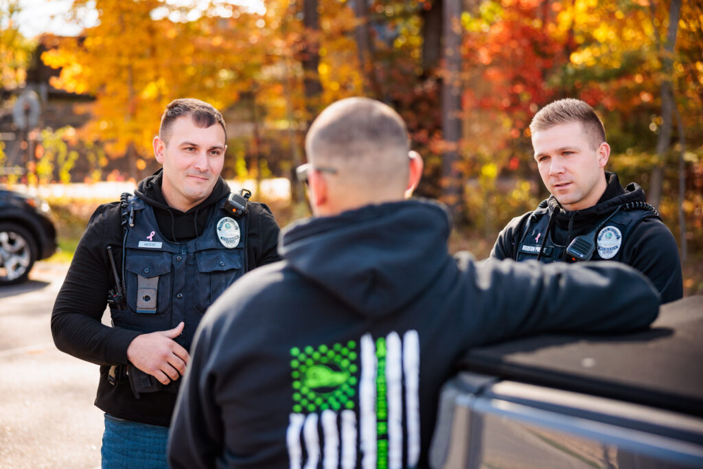 Two police officers talk to a citizen.