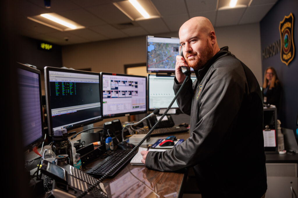 A white male dispatch manager talks on the phone.