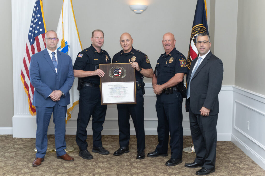 From left, MPAC Commission President Russell Stevens, Lt. Tom Crippen, Chief Richard DiPersio, Capt. Chad Perry, and Town of Hudson Executive Assistant Tom Gregory stand with the MPAC accreditation plaque. (Courtesy Stuart Beeby Photography via Hudson Police Department)