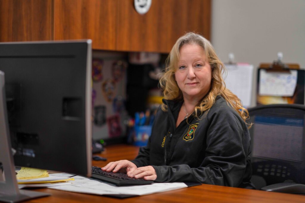 E911 staff member sitting at a desk.